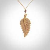 Hand carved woolly mammoth tusk fern pendant. Made in New Zealand. Unique hand made gifts from NZ Pacific. Hand carved fern necklace from ancient woolly mammoth tusk.